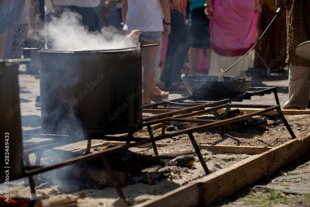 Shoulder of pork is boiling in a pan outdoors Shoulder of pork is boiling in a pan outdoors