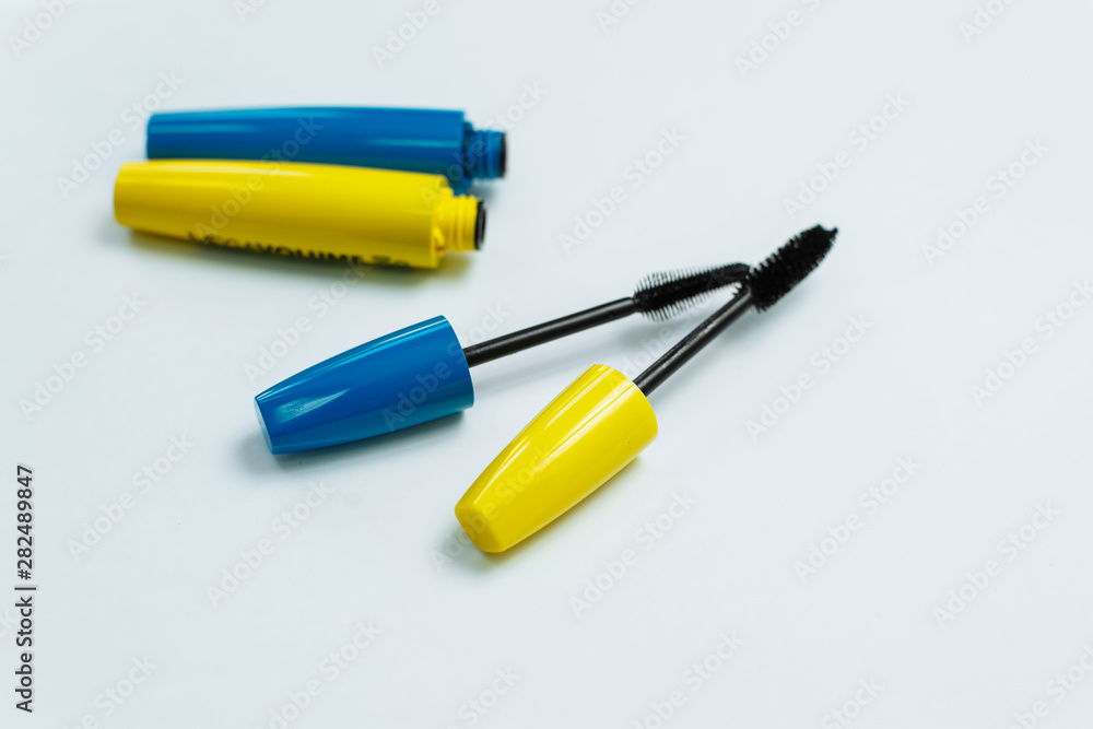yellow and blue mascara on a white background yellow and blue mascara on a white background