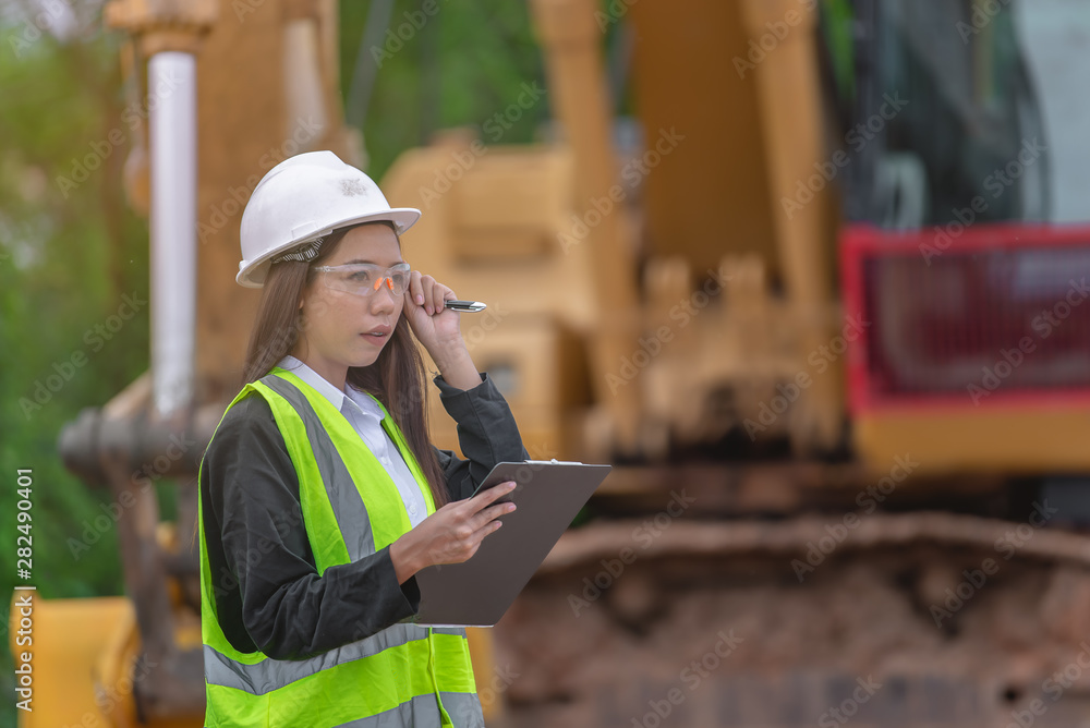 Asian engineer working at site of a large building project,Thailand people,Work overtime at construction site Asian engineer working at site of a large building project,Thailand people,Work overtime at construction site