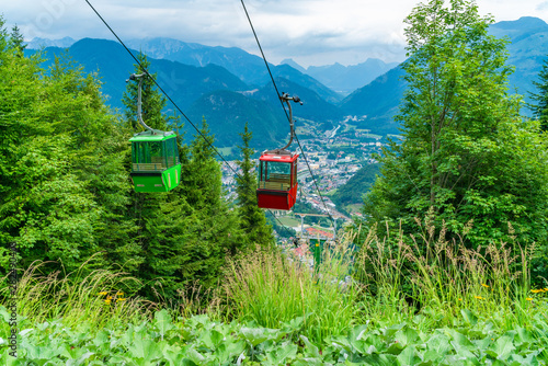 Colorful vintage gondolas of Mount Katrin cable car and panoramic alpine view of peaks over Bad Ischl, Salzkammergut, Austria