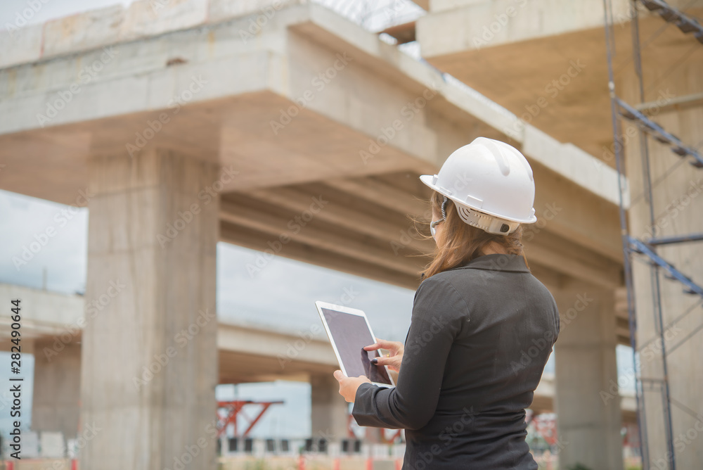 Engineer woman working at site of bridge under construction Engineer woman working at site of bridge under construction