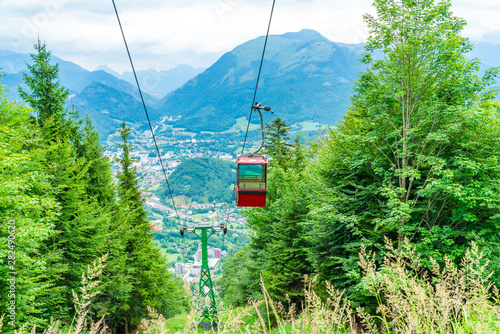 Colorful vintage gondola of Mount Katrin cable car and panoramic alpine view of peaks over Bad Ischl, Salzkammergut, Austria