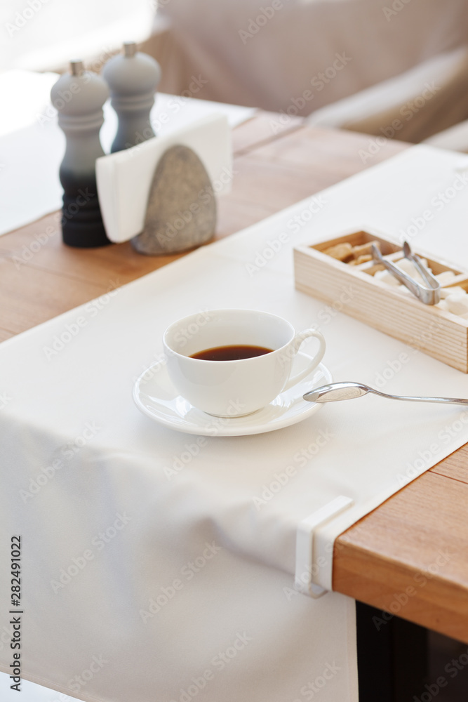 Cup coffee in park cafe. Modern design interior. Concept of vacation and leisure Cup coffee in park cafe. Modern design interior. Concept of vacation and leisure