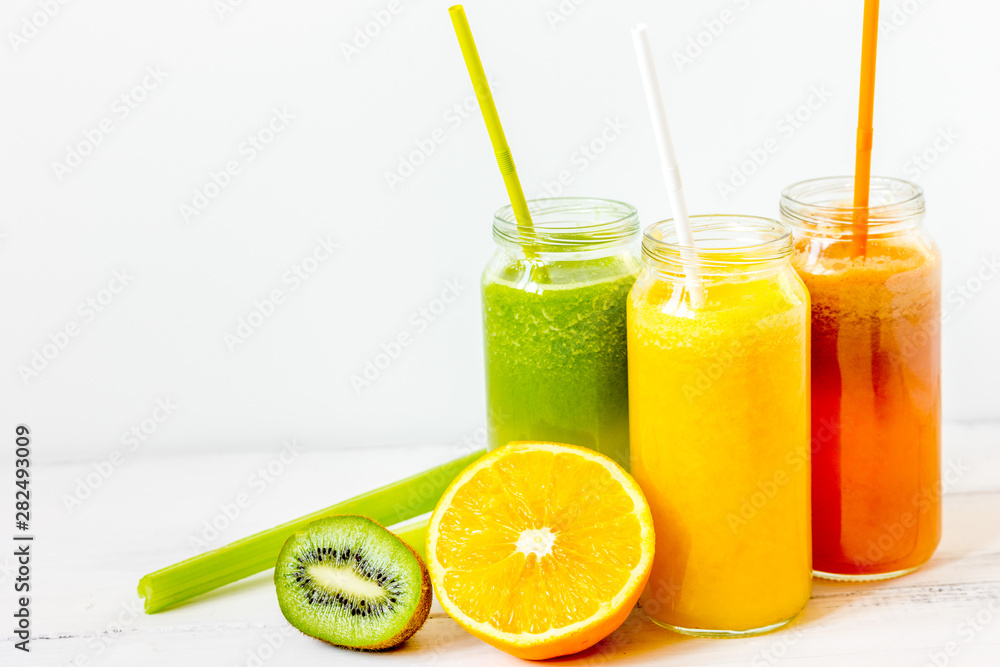 freshly squeezed juice in glass bottle on wooden background freshly squeezed juice in glass bottle on wooden background