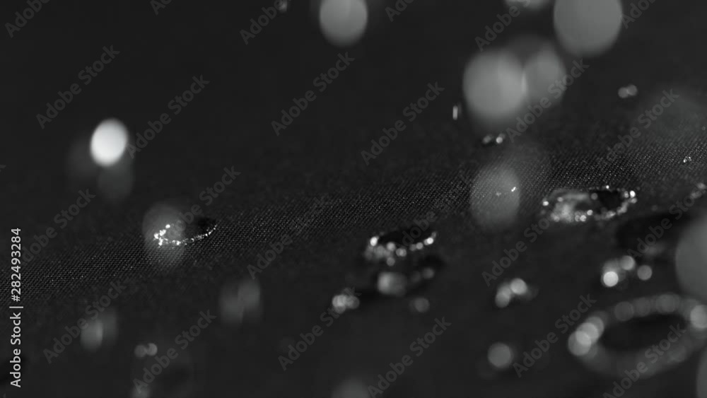 Super slow motion of falling water drops on waterproof cloth texture in detail. Filmed on high speed cinema camera, 1000 fps. Super slow motion of falling water drops on waterproof cloth texture in detail. Filmed on high speed cinema camera, 1000 fps.