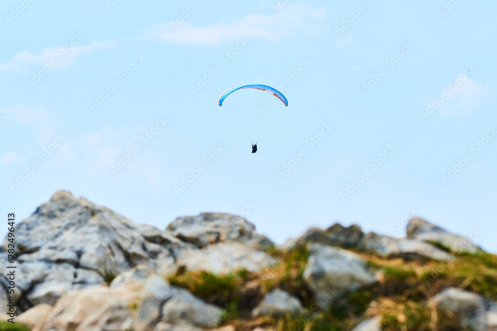 Paraglider flying over the Garda Lake (Lago di Garda or Lago Benaco). Paragliding on Monte Baldo. Panorama of the gorgeous Garda lake surrounded by mountains, Malcesine, Italy Paraglider flying over the Garda Lake (Lago di Garda or Lago Benaco). Paragliding on Monte Baldo. Panorama of the gorgeous Garda lake surrounded by mountains, Malcesine, Italy