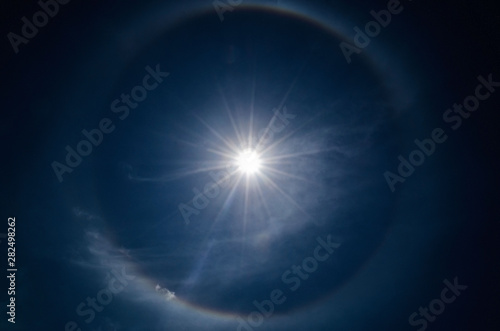 Halo in the blue sky around the sun