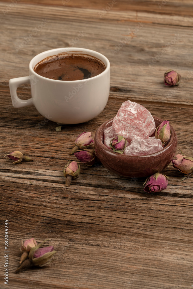 coffee and turkish delight on a wooden table decorated with dried roses coffee and turkish delight on a wooden table decorated with dried roses