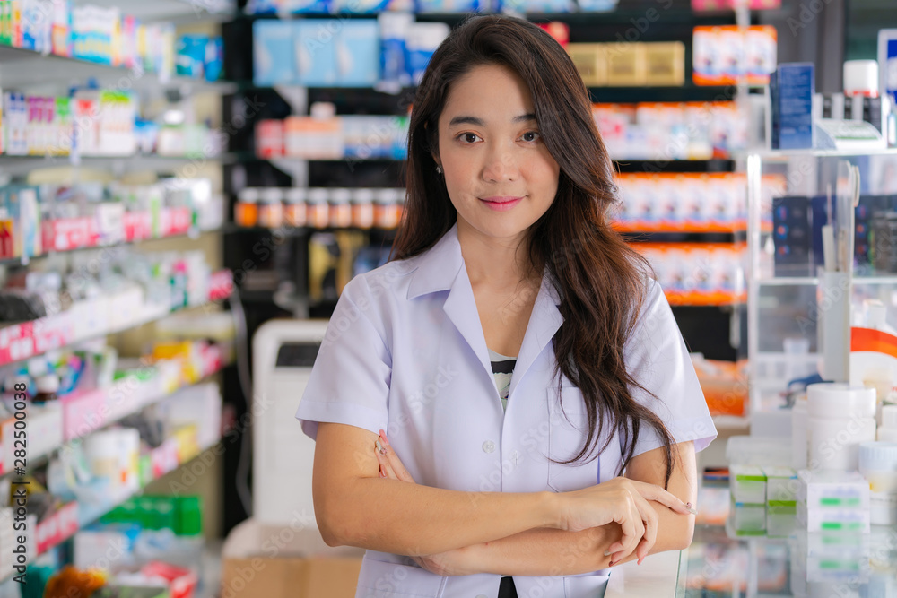 Smiling and happy of Asian female pharmacist in the pharmacy