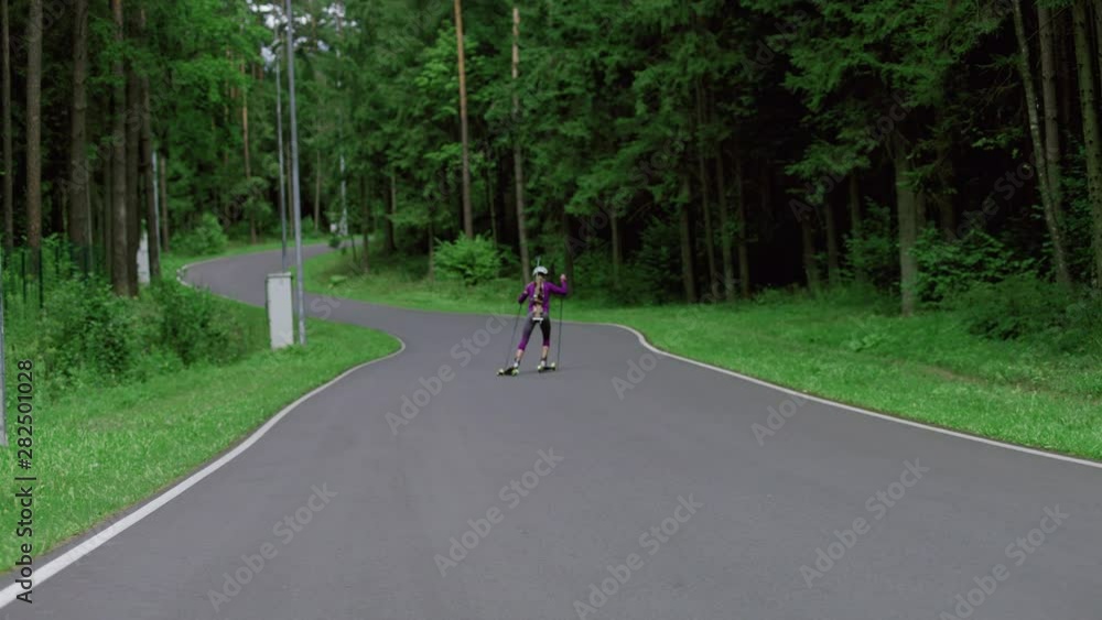 custom made wallpaper toronto digitalTRACKING Caucasian female professional biathlete roller skiing uphill on a forest track during mid-season practice in summer. ARRI Alexa Mini with Cooke S4 prime lenses RAW graded footage