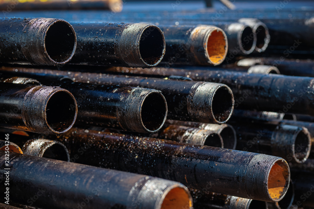 Close up drill pipe thread with pipe dope grease lay down on rig floor at oil and gas on shore location. Close up drill pipe thread with pipe dope grease lay down on rig floor at oil and gas on shore location.