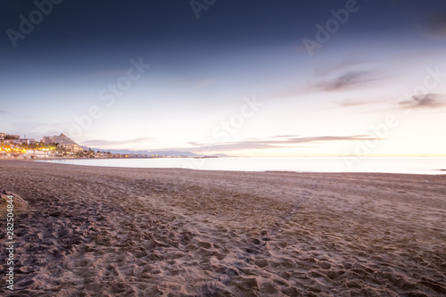 sun coming up over a beach