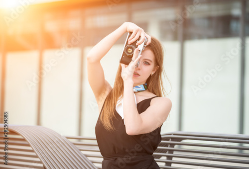Young and beautiful girl with vintage camera