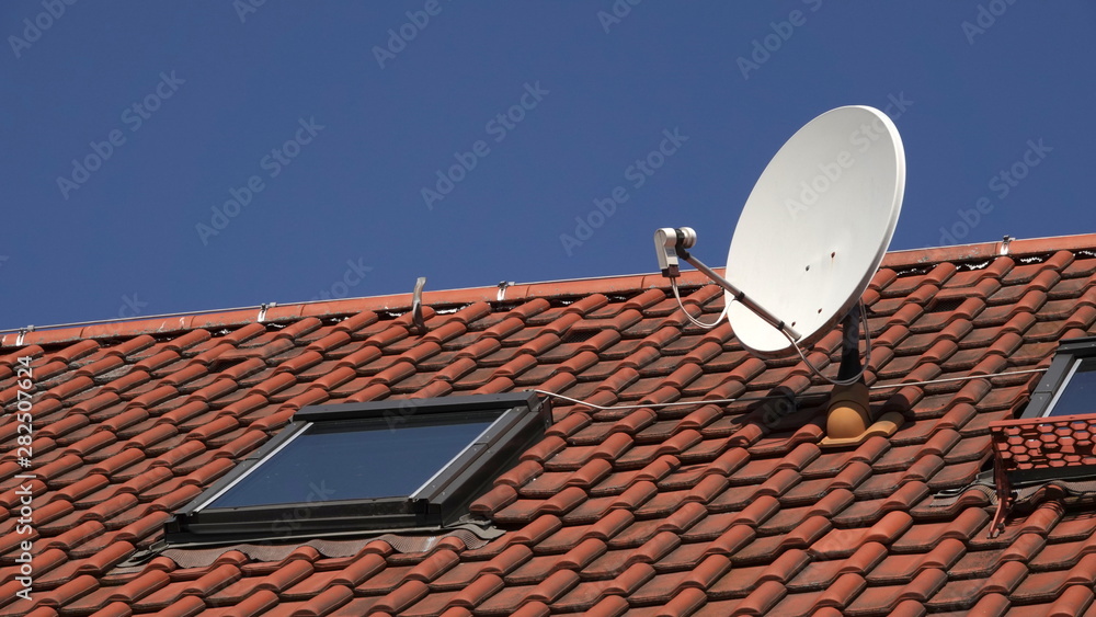 Satellite dish on red roof - obrazy, fototapety, plakaty 