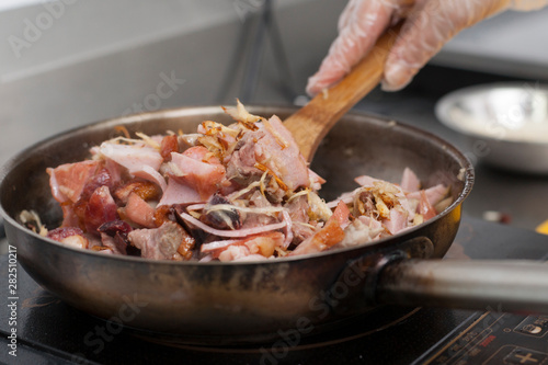 Cooking in frying pan with meat and vegetables 