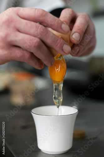man pouring an egg into a plate