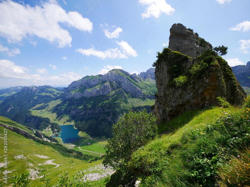 Fels ragt hoch über dem Seealpsee im schweizer Säntismassiv