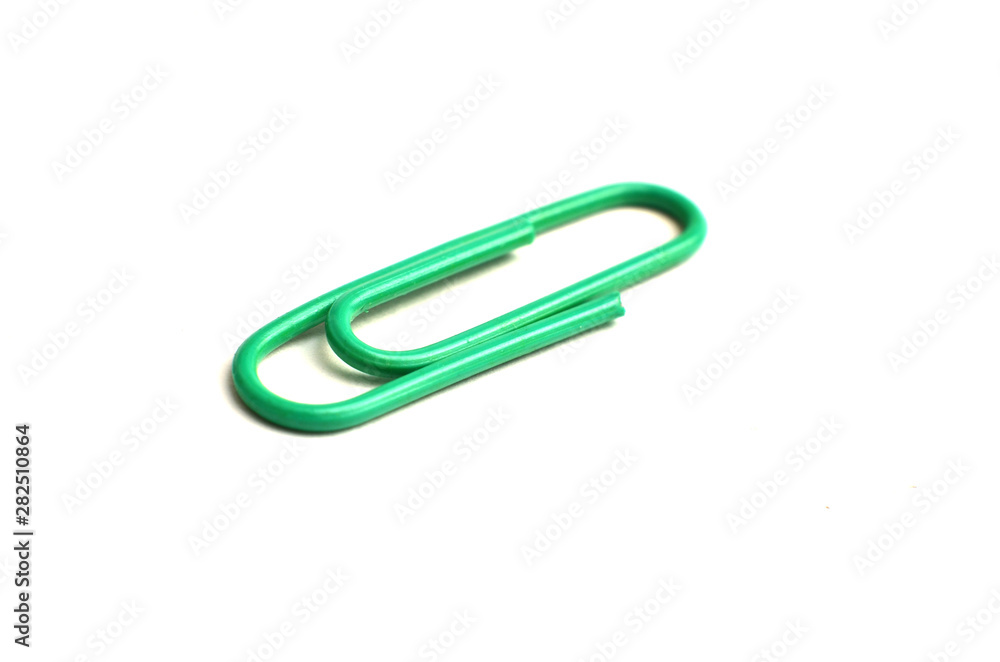 Paper clips, made of iron, are curved in a white background Paper clips, made of iron, are curved in a white background
