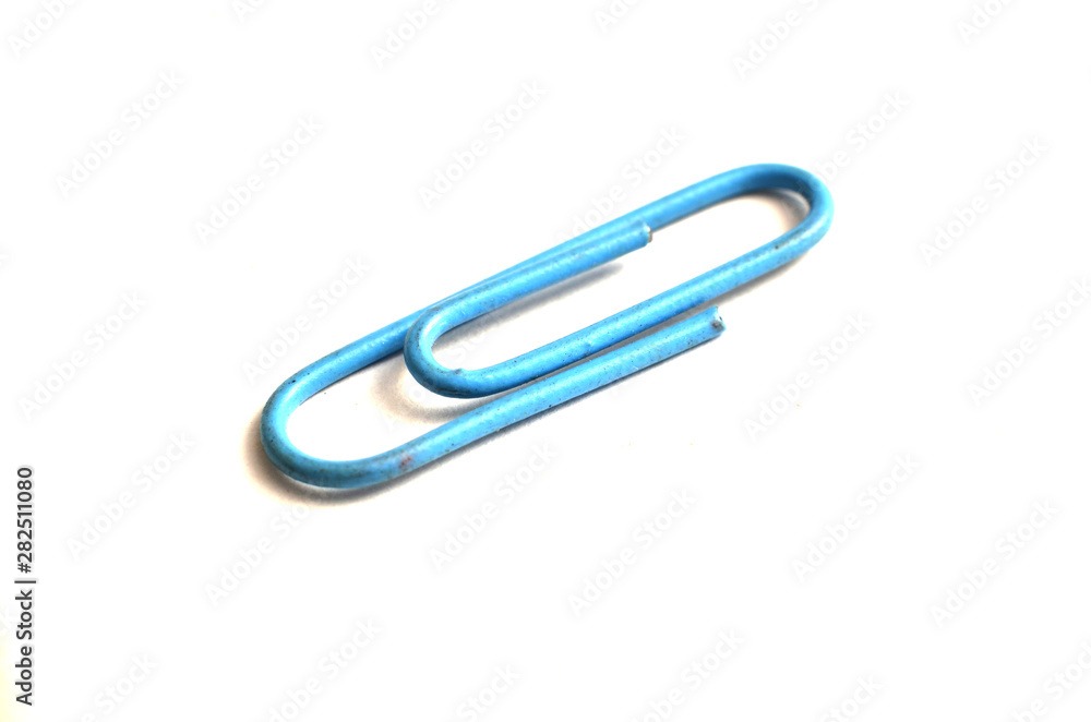 Paper clips, made of iron, are curved in a white background Paper clips, made of iron, are curved in a white background