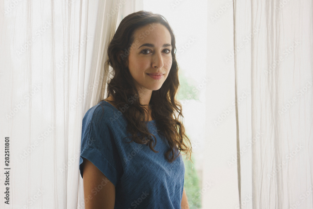 Portrait smiling, confident woman at window Portrait smiling, confident woman at window