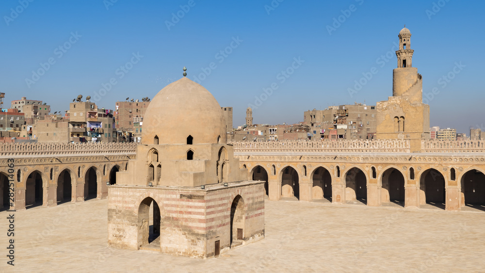 Courtyard of Ibn Tulun public historical mosque with ablution fountain and the minaret, Cairo, Egypt