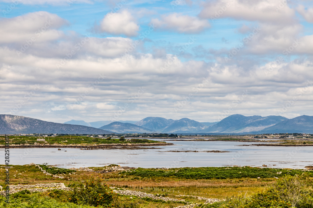 Farm field, Bay and mountains in Carraroe