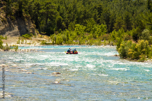 Rafting on a mountain river. Groups of people in boats when rafting in a rough current, rapids on a mountain river