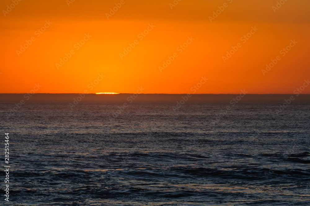 The sun sets over the horizon of the Atlantic Ocean