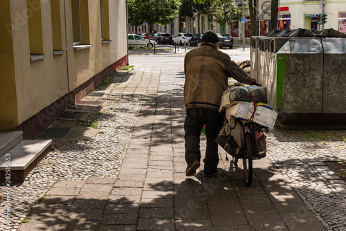 Wallpaper Mural Homless Man pushing his packed Bike, Homles Man from behind, Poverty, Homelessness  Torontodigital.ca