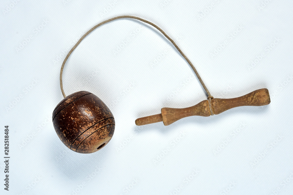 bilboquê, toy, old, brazilian, wooden ball tied by a rope on white background bilboquê, toy, old, brazilian, wooden ball tied by a rope on white background