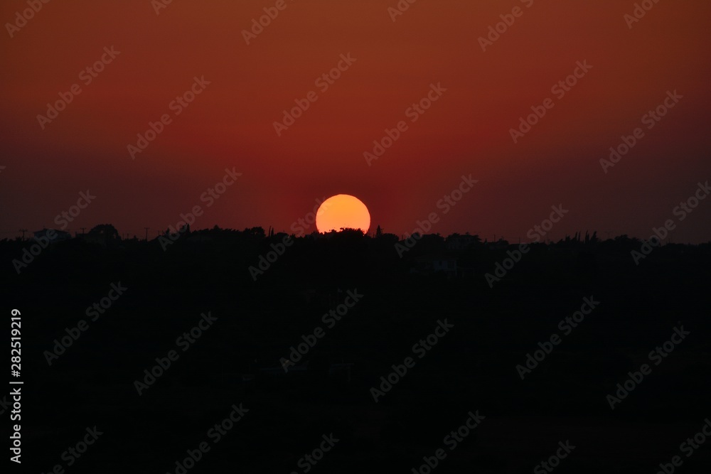 Obraz premium Perfect Cyprus sunset in the beautiful dark orange-red sky