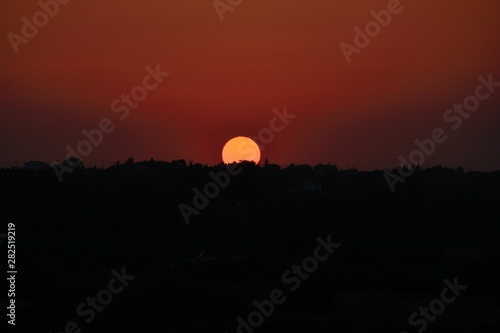 Perfect Cyprus sunset in the beautiful dark orange-red sky