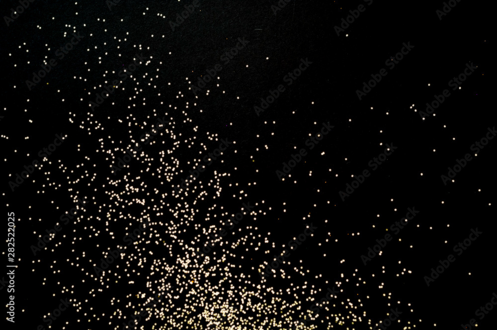Black background with golden sparkles. Blurred  effect