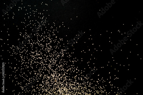 Black background with golden sparkles. Blurred effect