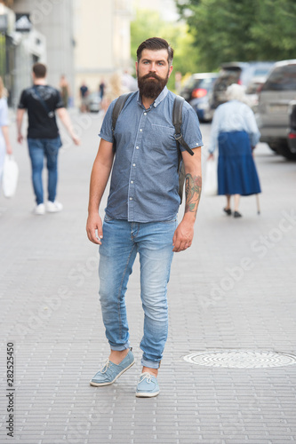 Mature hipster with beard. Bearded man. Confident brutal man walk street. Male hair barber care. brutal hipster with hiking backpack. adventure concept. urban style. Adventure awaits, go find it