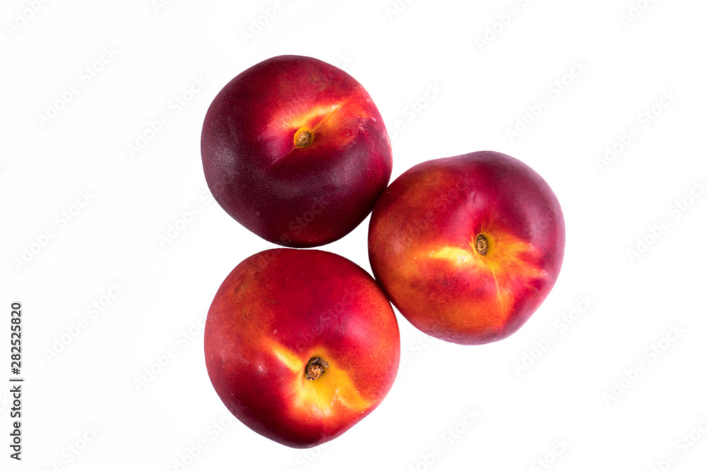 three peaches nectarine on a white background