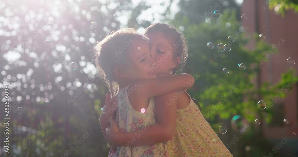 Authentic shot of two cute little girls sisters hugging having fun ...