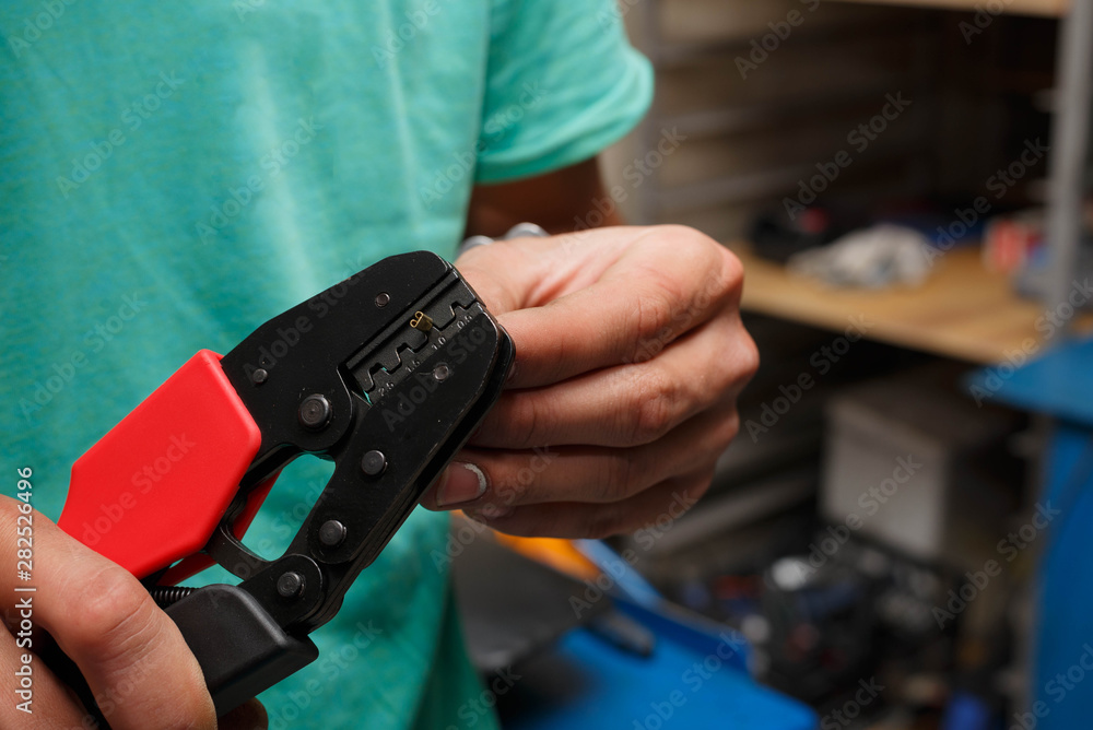 The wizard is preparing a new electrical wire to replace the damaged one on the motorcycle. The wizard is preparing a new electrical wire to replace the damaged one on the motorcycle.