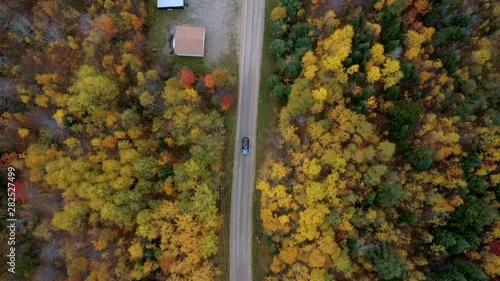 Aerial Exit: Blue Car On Road In Bright Forest Covered Plain - Dixville Notch, New Hampshire photo