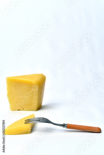piece of cheeseon the table on white background