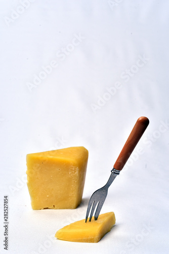 piece of cheeseon the table on white background photo