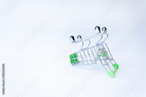 upside down shopping supermarket cart on white background photo