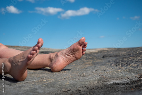 Feet on rocky beach