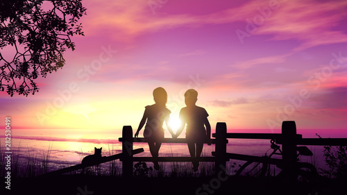 A boy and a girl hold hands in the rays of the setting sun