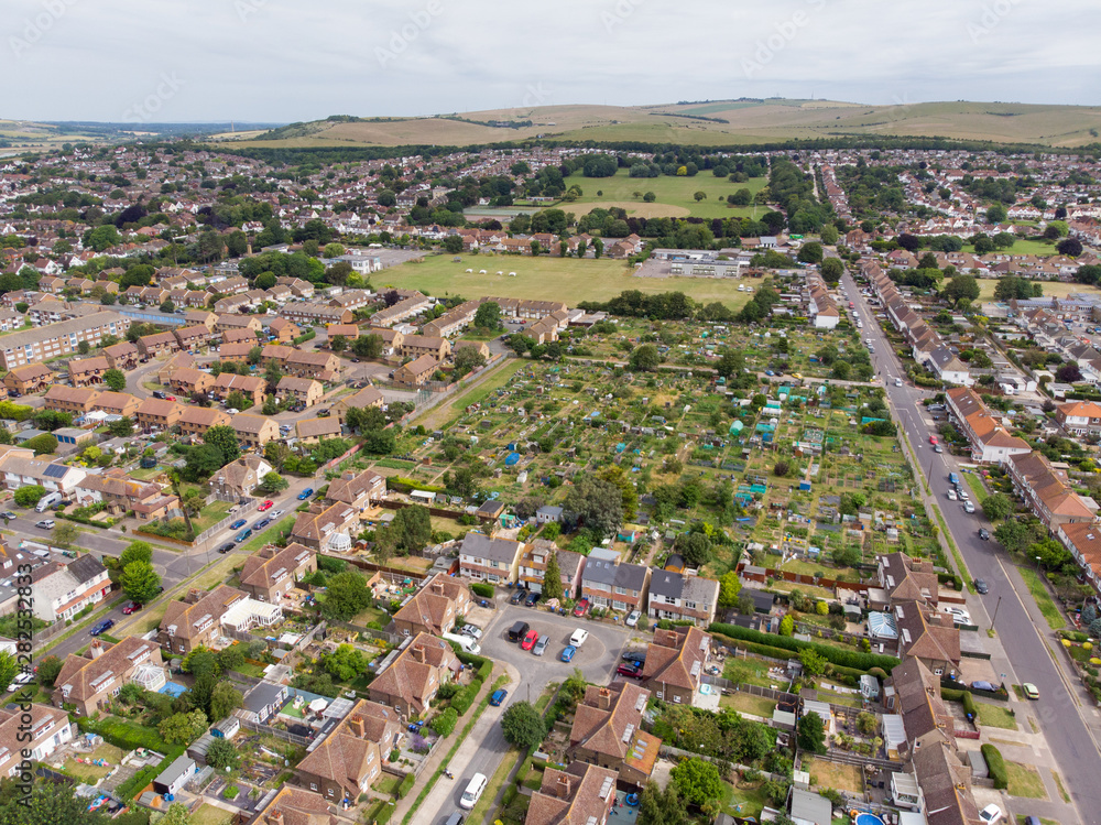 Aerial photo of the town of Shoreham-by-Sea, a seaside town and port in West Sussex, England UK, showing typical housing estates and businesses taken on a bright sunny day.