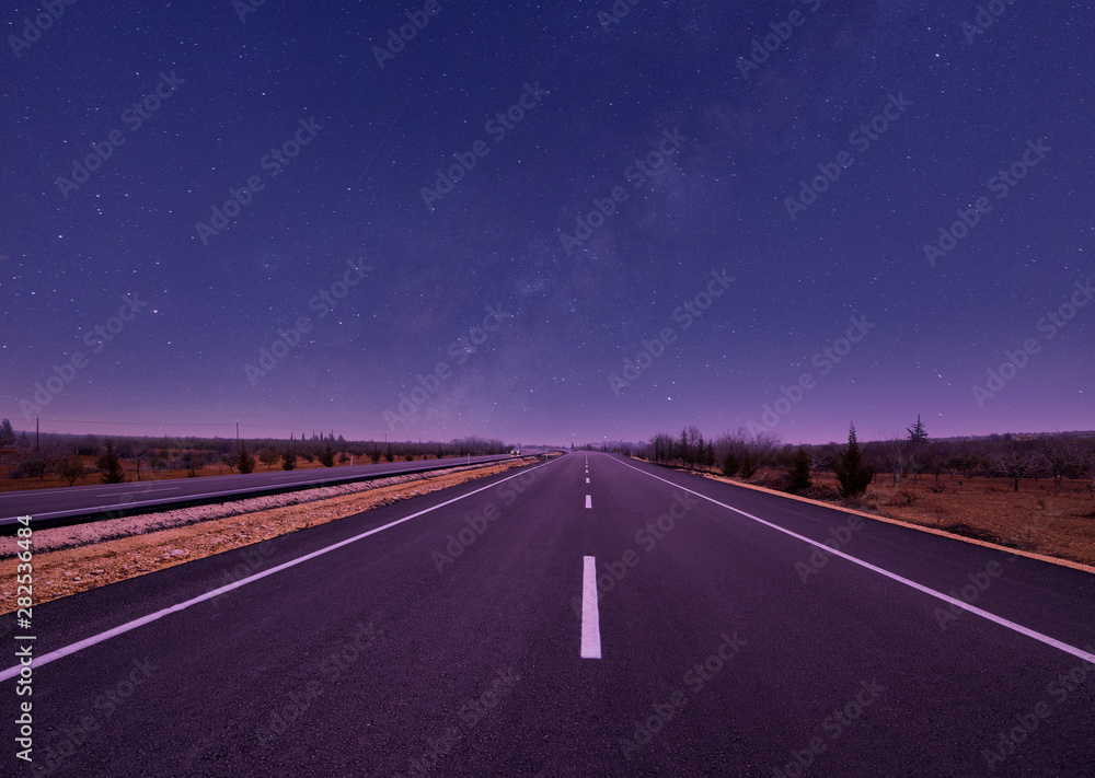 view of asphalt road and night sky
