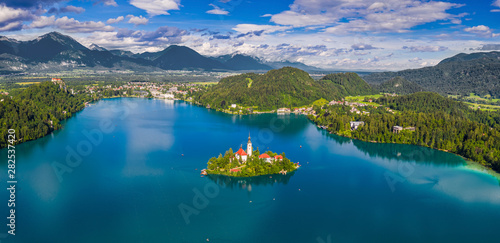 Bled, Slovenia - Aerial panoramic skyline view of Lake Bled (Blejsko Jezero) with the Pilgrimage Church of the Assumption of Maria, Bled Castle and Julian Alps at background on a bright summer day