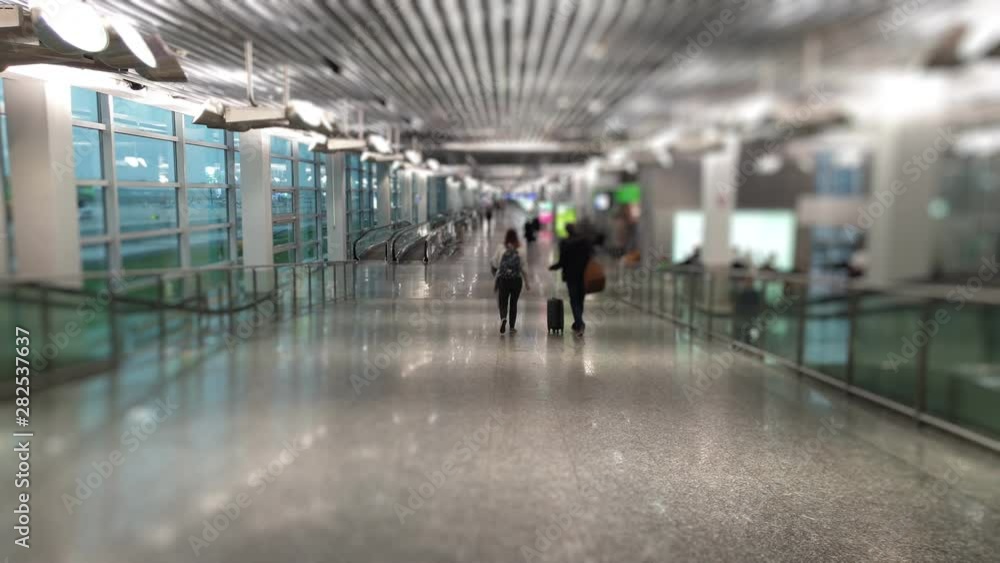 Unidentified people walking on foot at the airport. Unidentified people walking on foot at the airport.