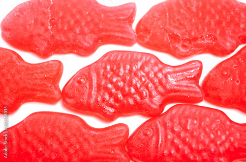 Isolated red fish-shaped jelly. Jellyfisk with strawberry flavor. Typical norwegian and swedish sweets called Jordbærfisker.
