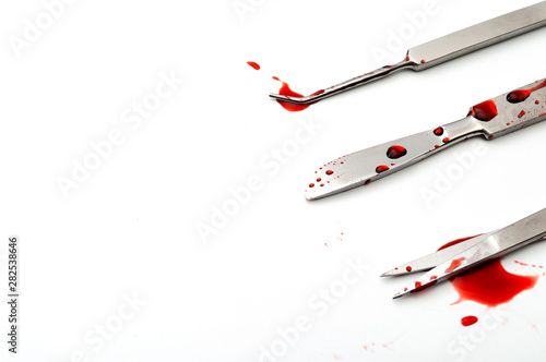 Messy operation room or OR, botched surgery and surgical instruments concept theme with bloody scalpel, scissors and medical probe isolated  on white background with copy space